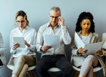 Large group of business people waiting for a job interview.